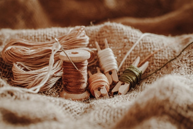 Threads wooden hoop on the background of old fabric burlap