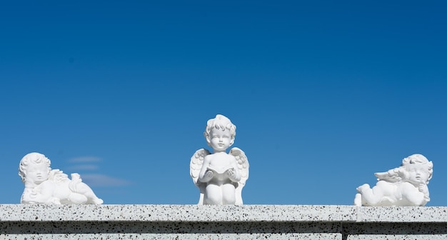 three angels statues background with copy space