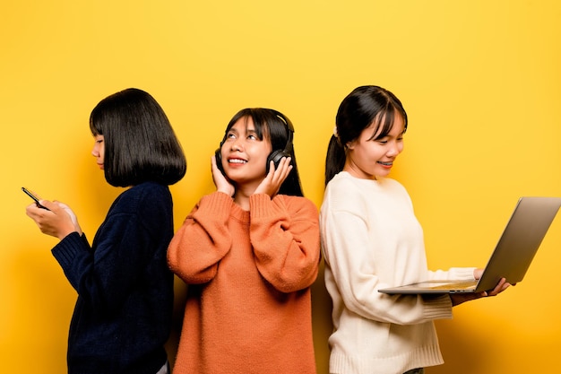 Three Asian women working with laptop and phone at the same time The two of them were