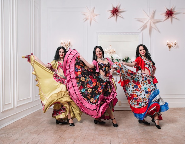 Three attractive female dancers performing a gypsy dance