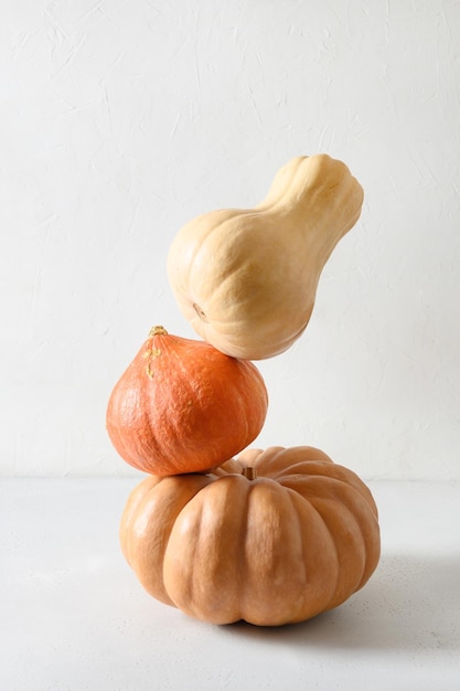 Three balanced pumpkins for Halloween or Thanksgiving Day fest