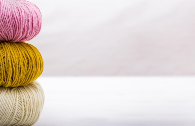 Photo three balls of yarn closeup on light background with copy space