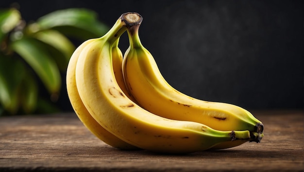 three bananas are on a wooden table one of which has a green leaf