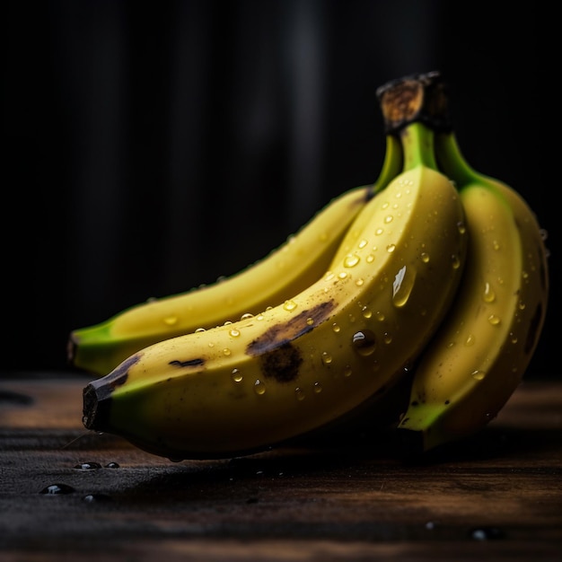 Three bananas with water drops on them on a wooden table.