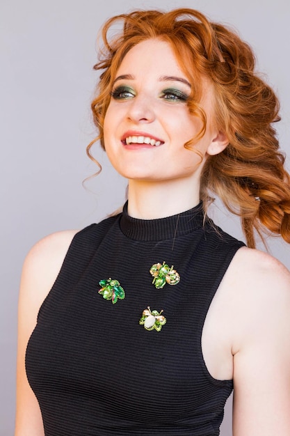 Three beetle brooches on a redhaired girl's black turtleneck