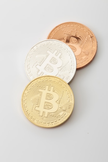 Three Bitcoins Coins on white