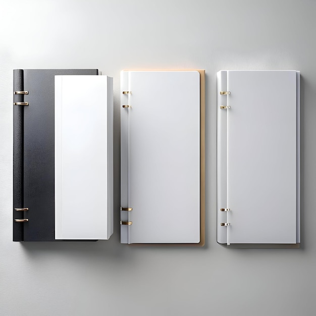 Three blank notebooks in black white and brown with gold rings