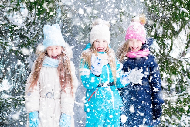 Three blond happy girls having fun in forest