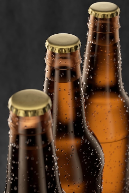 Three bottles of cold beer with drops frost and steam on black 3D rendering