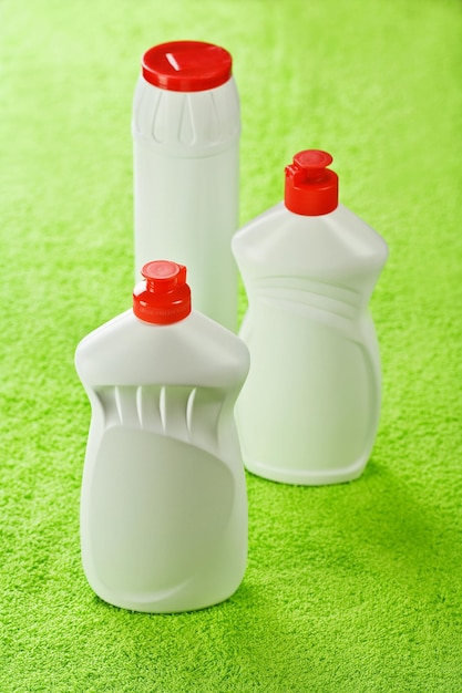 Three bottles on green towel