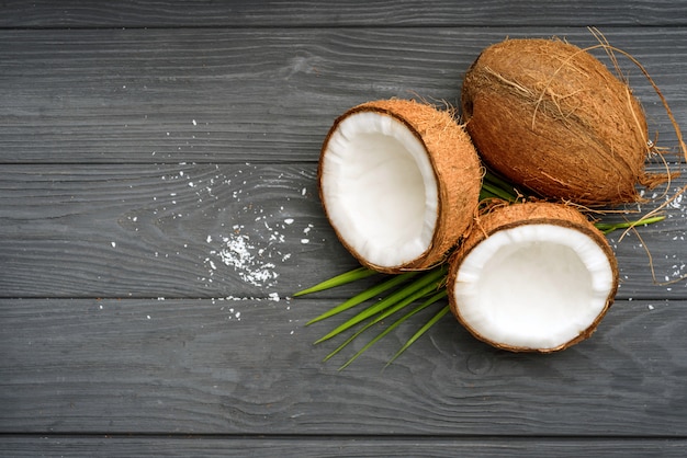 Three brown coconut on old wooden board