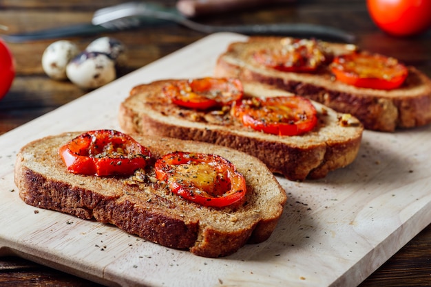 Three Bruschettas on Cutting Board