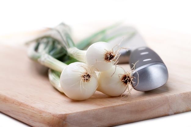 Three bulbs spring onions on white background