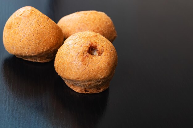 Three buns on a wooden table closeup