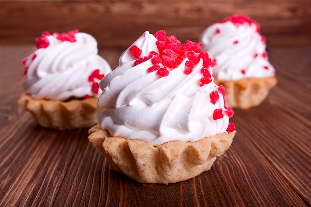 Three cakes close-up on wooden background. selective focus