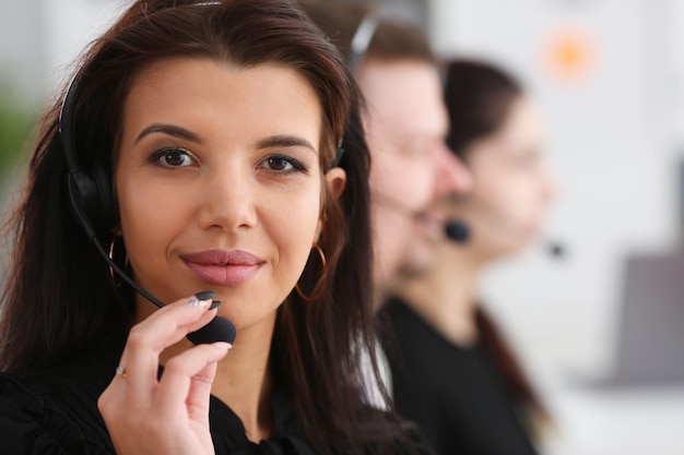 Three call centre service operators at work