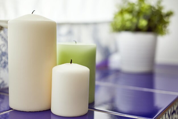 Three candles on windowsill in bathroom