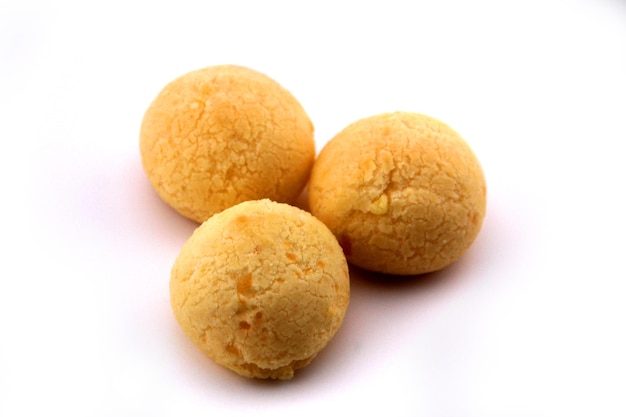 Three cheese breads from Minas Gerais are shown on the white background seen from the side