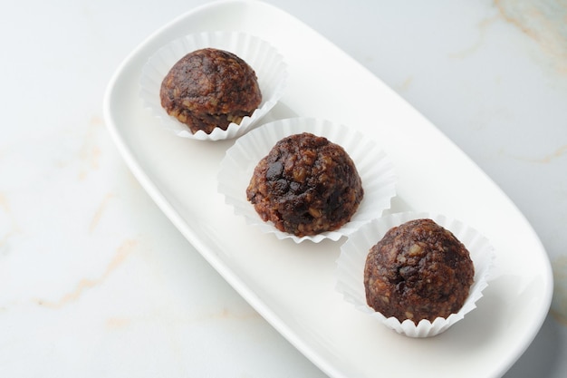 Three chocolate candies sweets on white plate