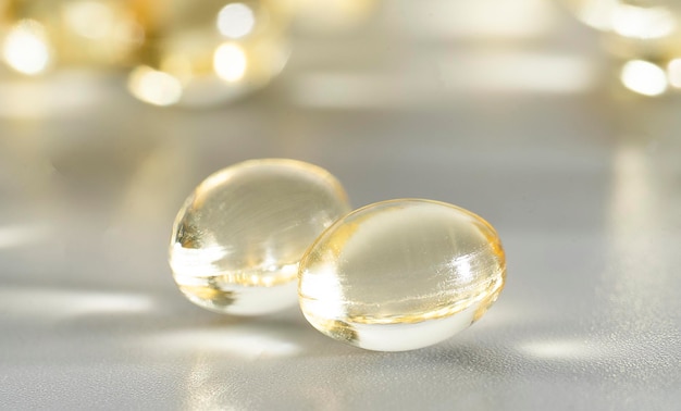 Three clear pills on a white surface