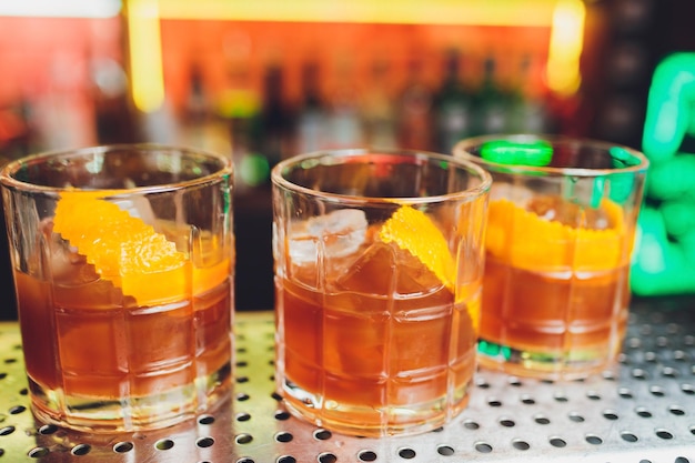 Three cocktails on the bar whiskey cola rum cola whiskey with juice on the bar during a nightclub