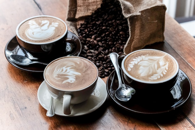 three coffee cups and coffee beans