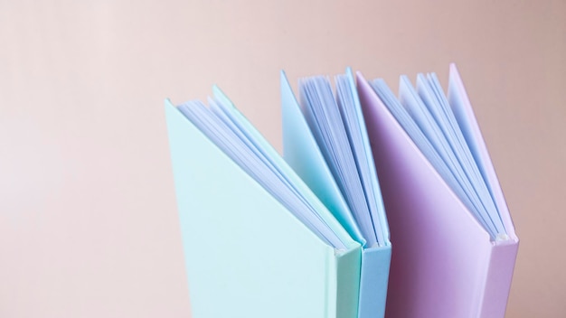 Three colored open books with blank cover