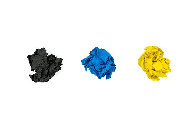 Three colorful crumpled paper balls isolated on white background Black blue and yellow wrinkled