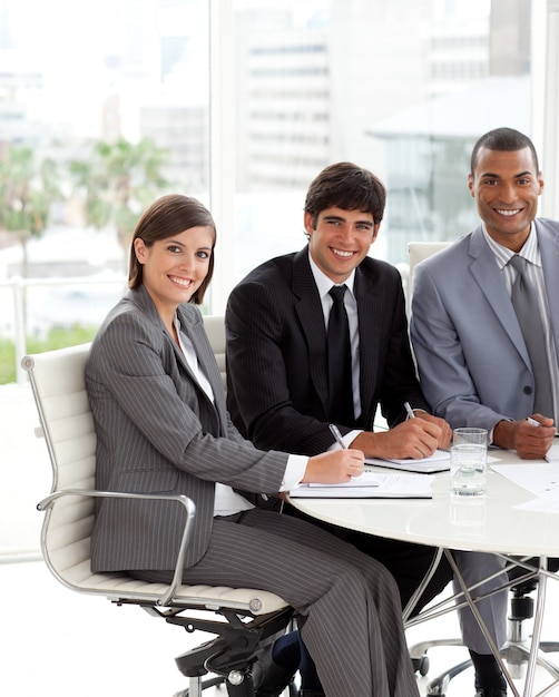 Three coworkers smiling at the camera 