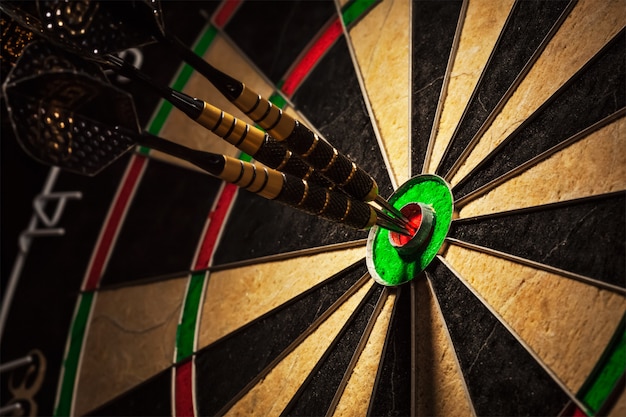 Three darts in bull's eye close up