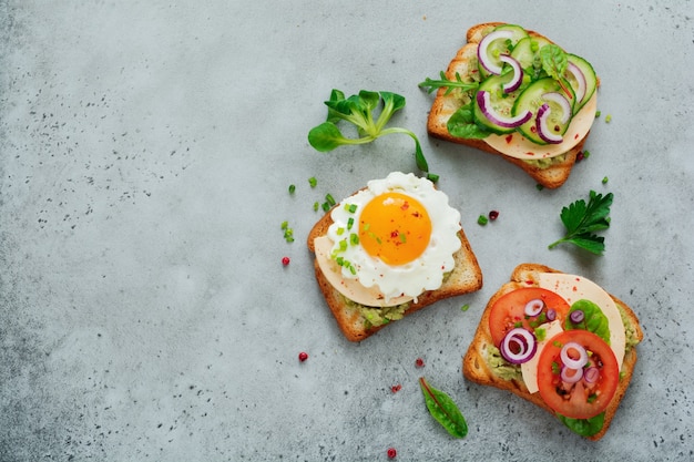 Three different toast sandwiches with guacamole sauce