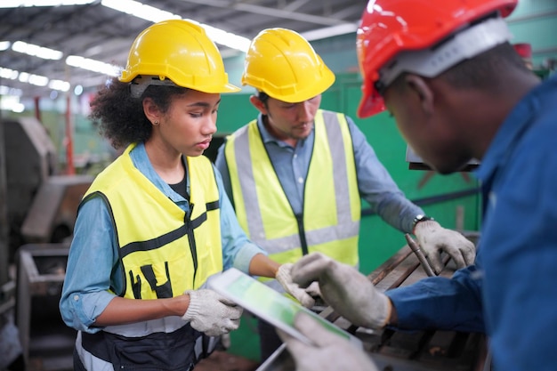 Three Diverse Multicultural Heavy Industry Engineers and Workers in Uniform at Steel Factory