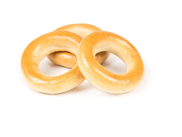 Three dry bagels isolated on white background