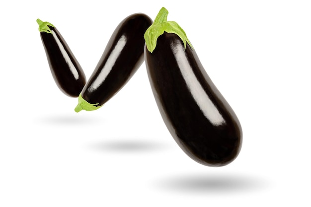 Three eggplants in a row over white