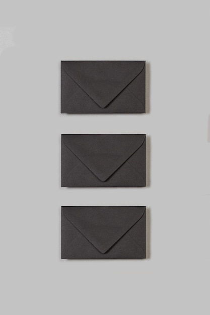 Three envelopes on a gray background with copy space