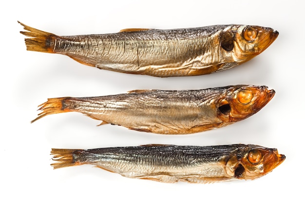 Three fish smoked sprat golden color on a white background