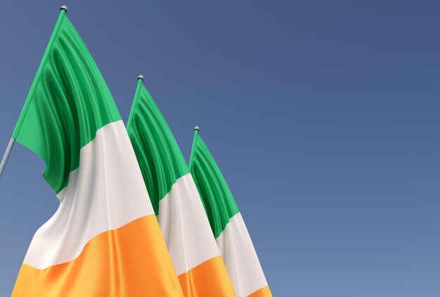 Three flags of Ireland on flagpole on blue background Place for text The flag is unfurling in wind Dublin Europe Irish 3D illustration