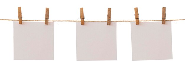 Three frames that hang on a rope with clothespins and isolated on white Blank cards on rope mockup template clipping path