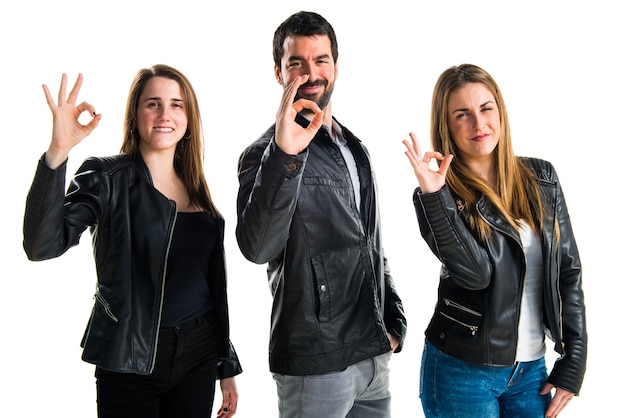 Three friends making OK sign