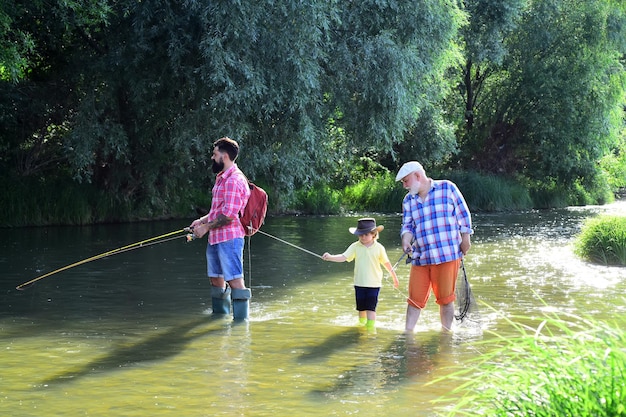 Three generations ages grandfather father and young teenager son Old and young Dad and son fishing a