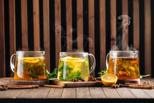 Three glass pots of various hot tea