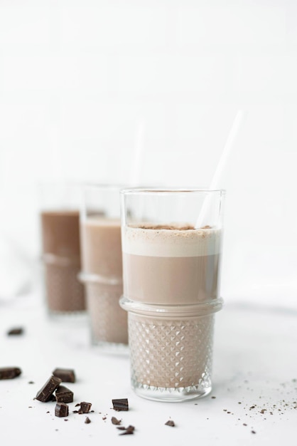 Three glasses with chocolate milkshakes