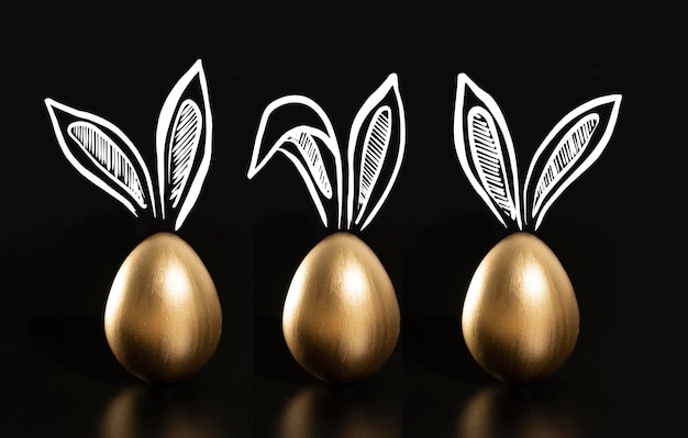 Three gold easter eggs with ears drawn on them, one of which has a rabbit ears.