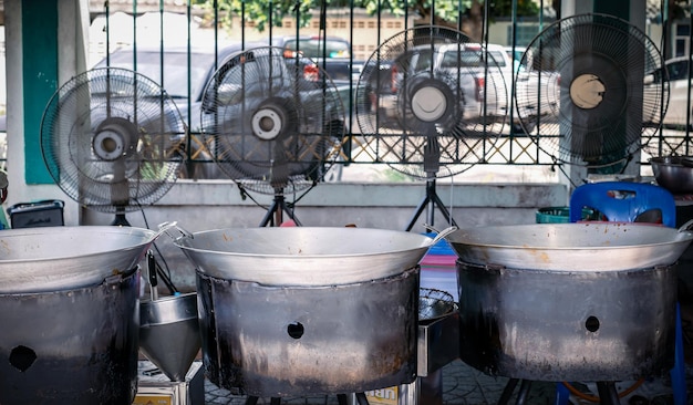 Three large Pans are fried the fried chicken