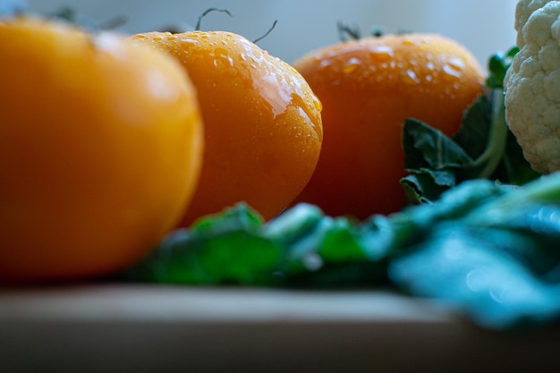 Three large yellow tomatoes lie on the table