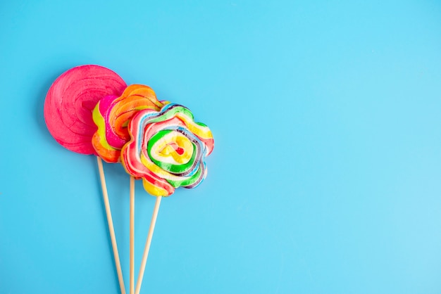 Three Lollipop on a blue background, copy space