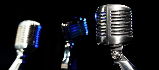 Three metal retro microphones on the stand