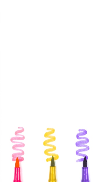 Three multicolored markers on a white background