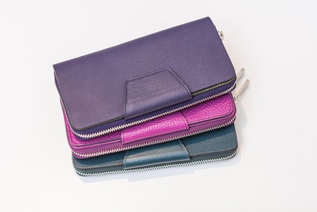 Three multicolored purses on a white table