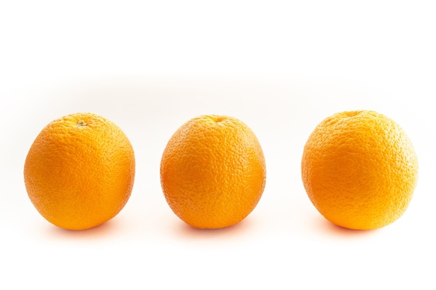 Three oranges on a white background